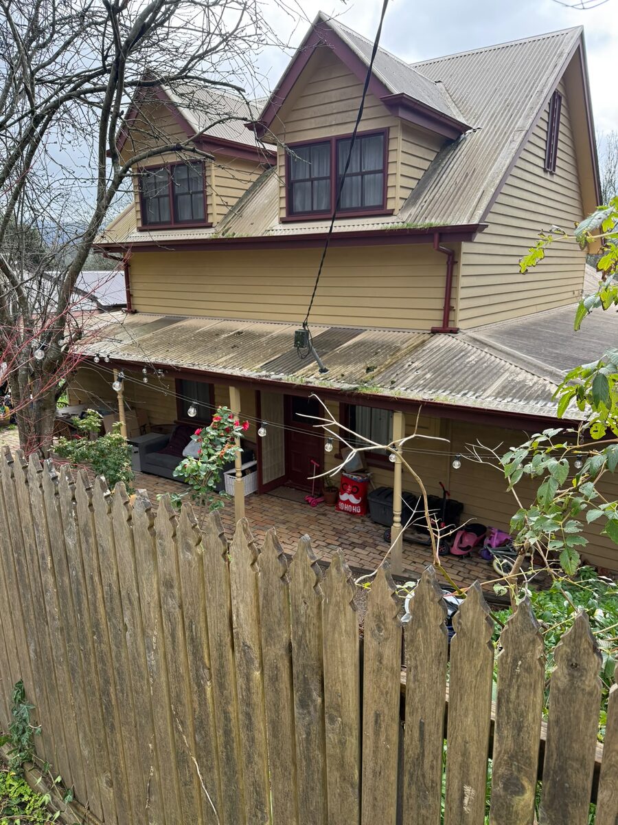 Home frontage with timber fence and painted exterior